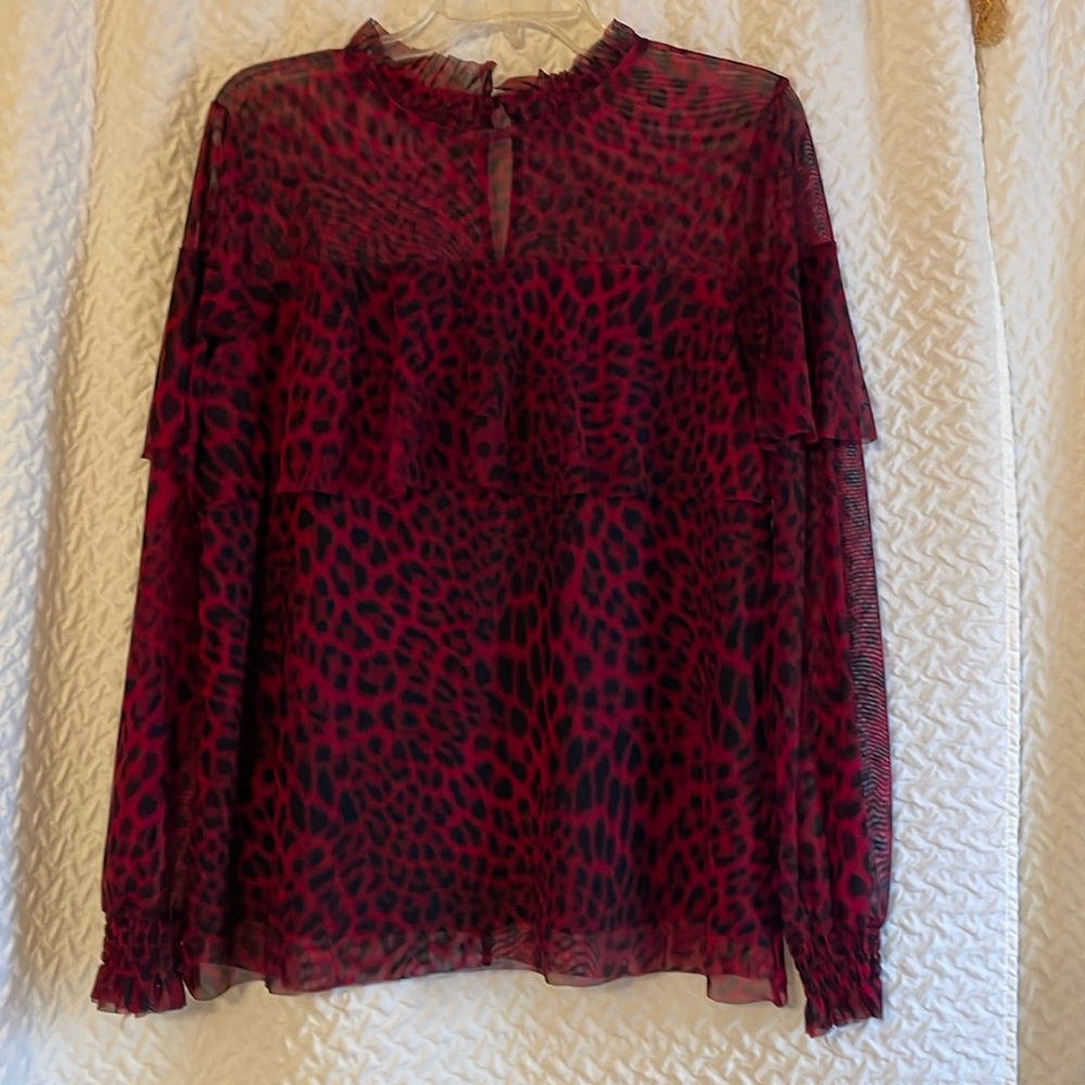 Sheer long sleeve blouse with black lining.